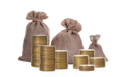 Stacked coins and sack full of money on white background