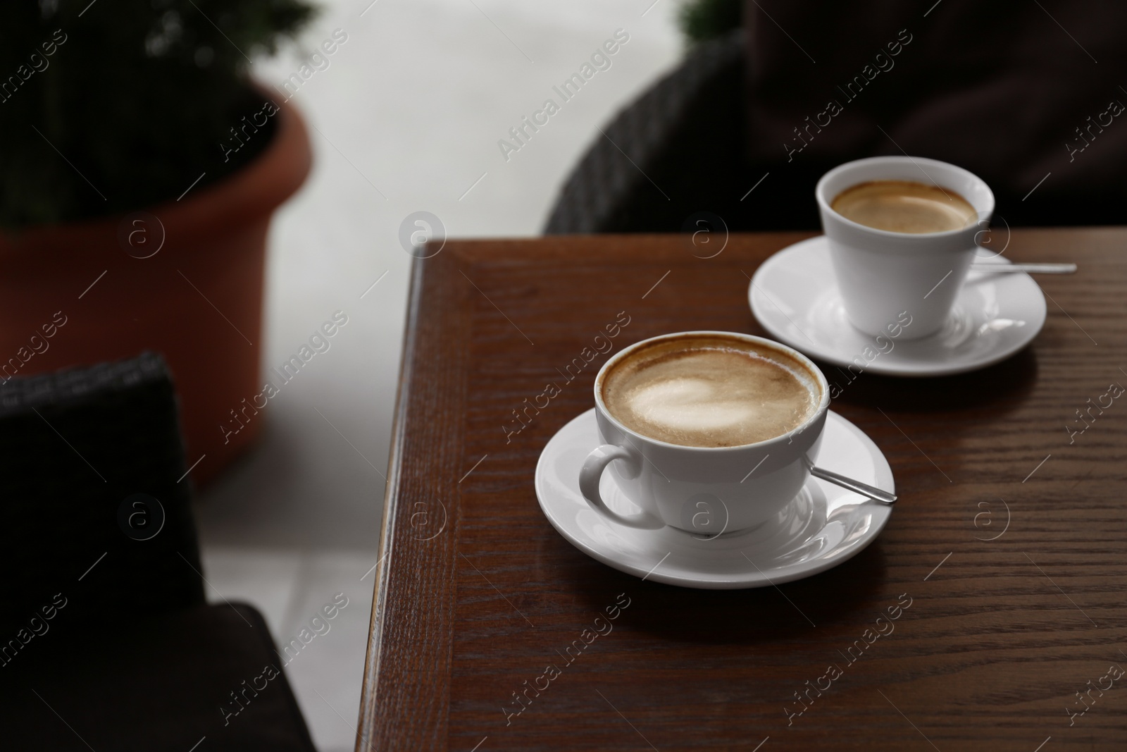 Photo of Cups of delicious aromatic coffee on table