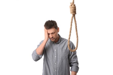 Photo of Depressed man with rope noose on white background