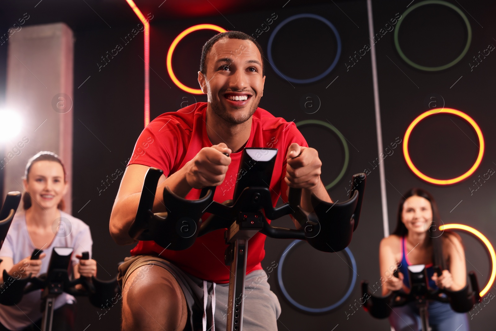 Photo of Group of people training on exercise bikes in fitness club