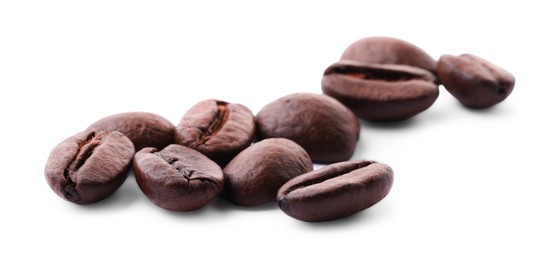 Photo of Many roasted coffee beans isolated on white