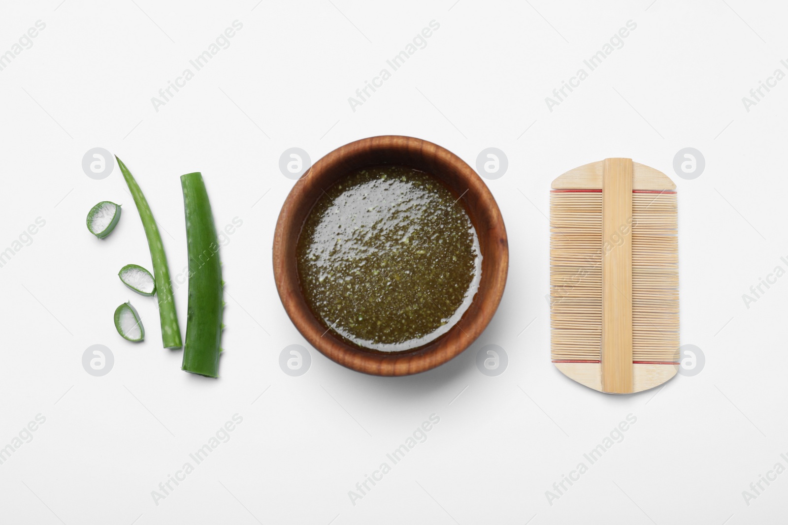 Photo of Homemade hair mask in bowl, aloe and bamboo comb on white background, top view