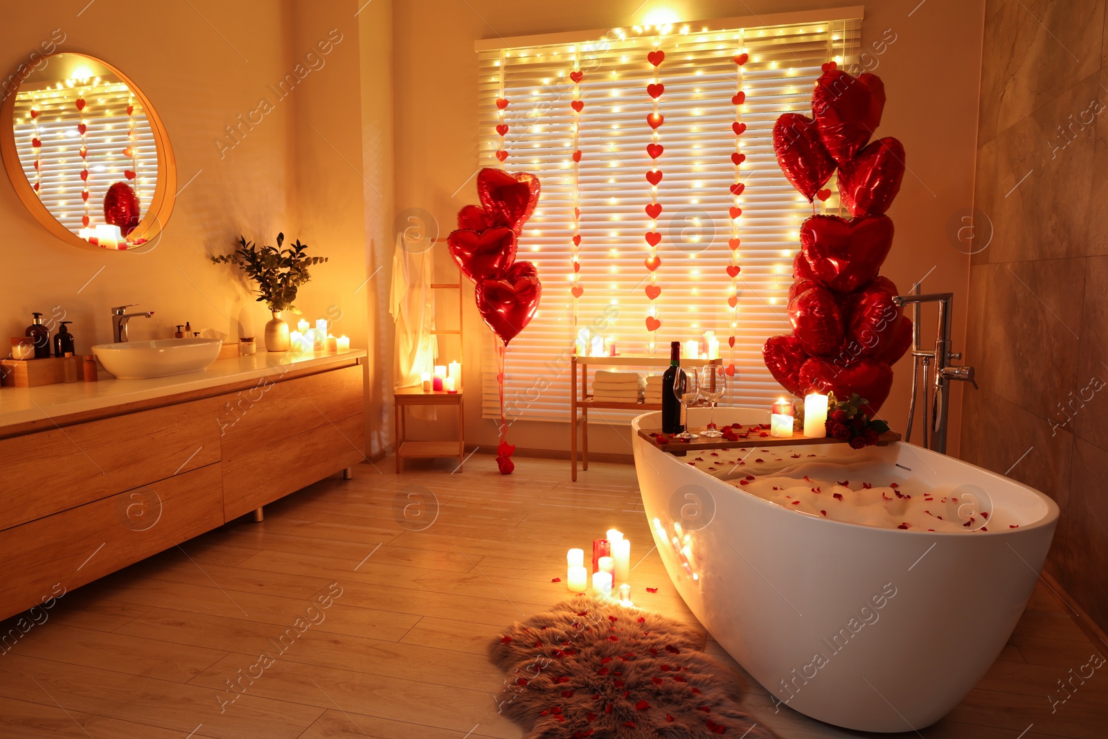 Photo of Stylish bathroom decorated for Valentine's day. Interior design