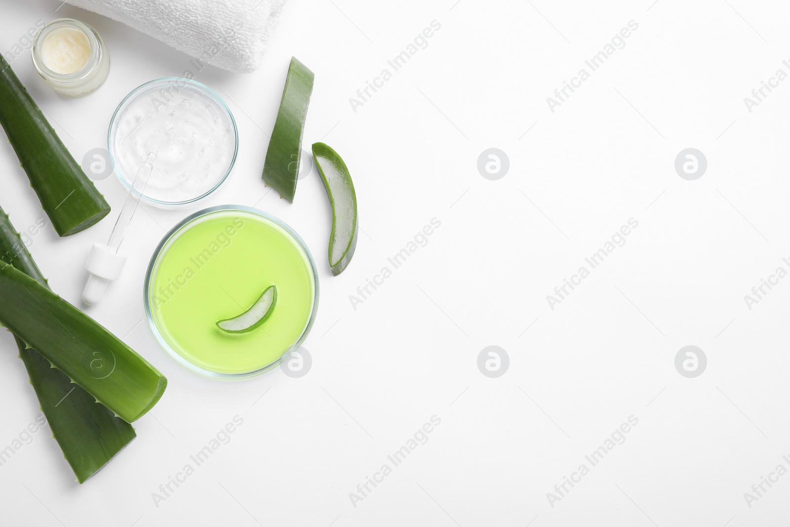 Photo of Flat lay composition with cosmetic products and cut aloe leaves on white background. Space for text