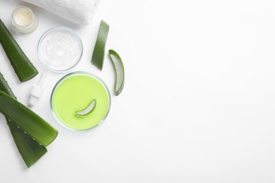 Photo of Flat lay composition with cosmetic products and cut aloe leaves on white background. Space for text