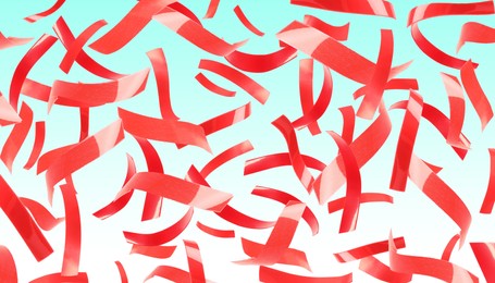 Image of Bright red confetti falling on gradient light blue background. Banner design