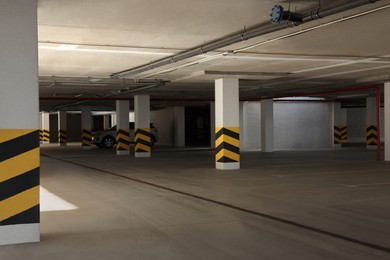 Photo of Car parking garage with warning stripes on columns