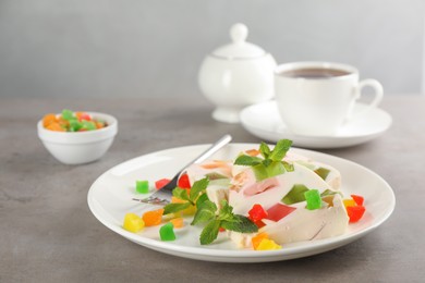 Photo of Delicious broken glass jelly dessert on grey table