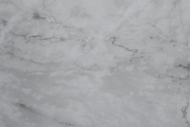 Photo of Texture of light grey marble surface as background, closeup