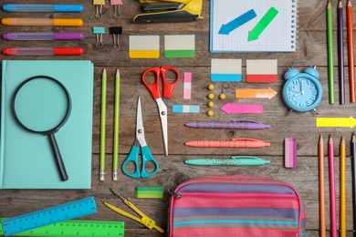 Different school stationery on wooden background, flat lay