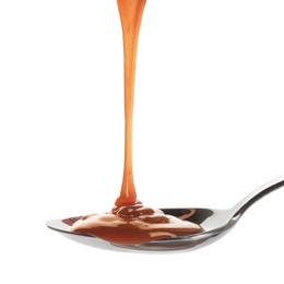 Photo of Tasty caramel sauce pouring into spoon isolated on white