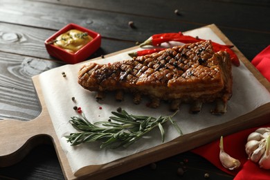 Photo of Delicious roasted ribs served on wooden table