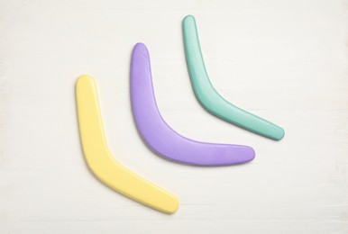 Boomerangs on white wooden background, flat lay