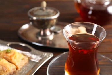 Photo of Traditional Turkish tea in glass on table, closeup. Space for text