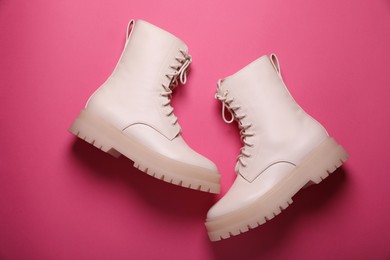 Photo of Pair of stylish leather shoes on pink background, flat lay