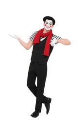 Photo of Funny mime artist in beret posing on white background