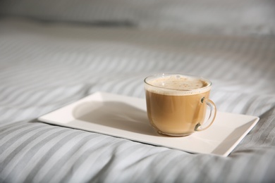 Photo of Tray with morning coffee on soft blanket. Space for text