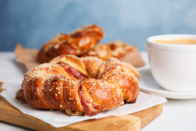 Delicious pastries and coffee on white table, closeup