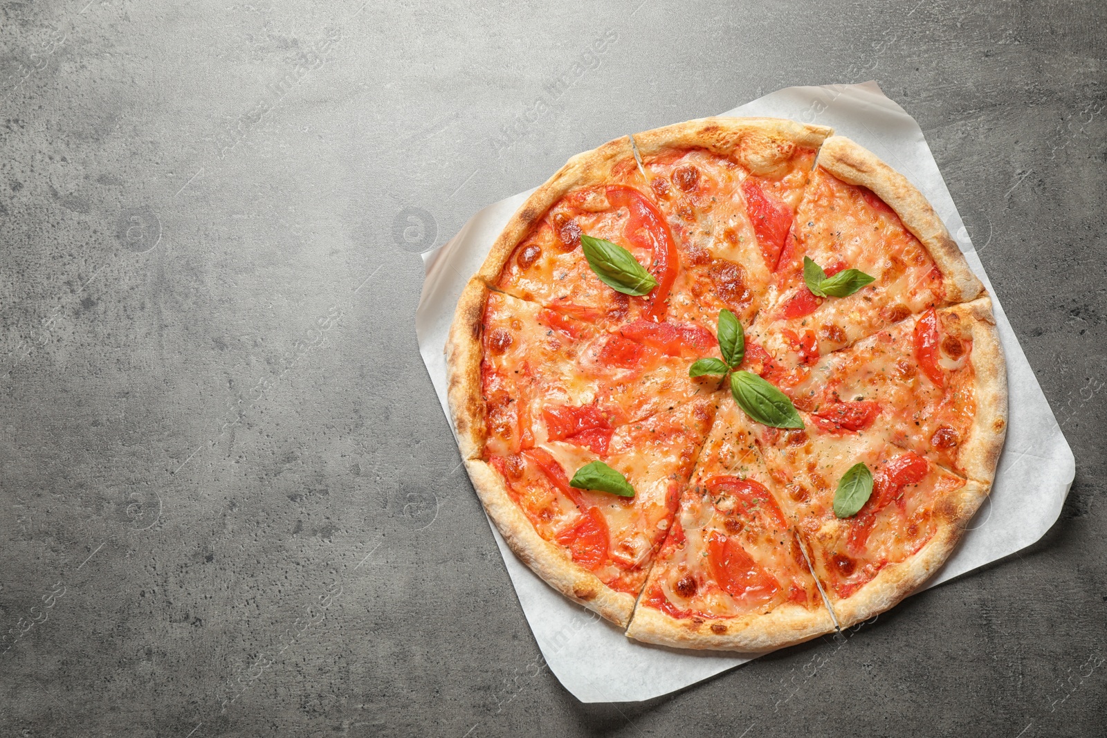 Photo of Delicious pizza Margherita on grey table, top view. Space for text
