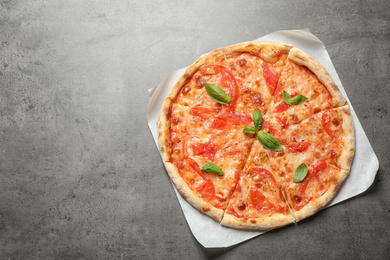 Delicious pizza Margherita on grey table, top view. Space for text