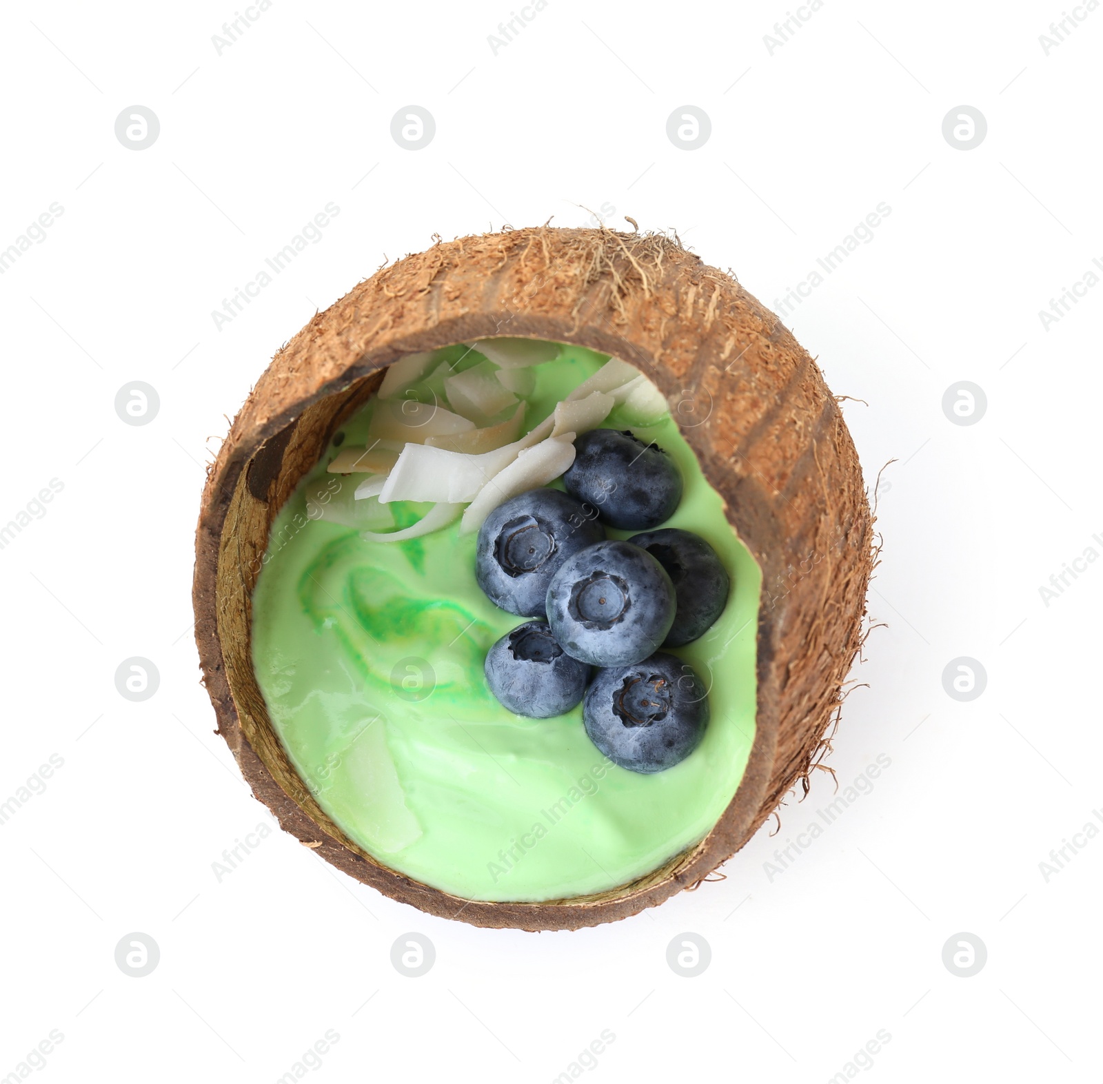 Photo of Tasty smoothie bowl with fresh blueberries in coconut shell isolated on white, top view