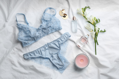 Photo of Flat lay composition with sexy women's underwear on white fabric