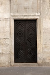 View of building with vintage wooden door. Exterior design