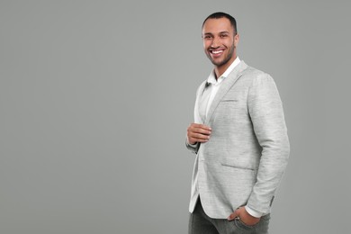Photo of Young businessman in formal outfit on grey background. Space for text