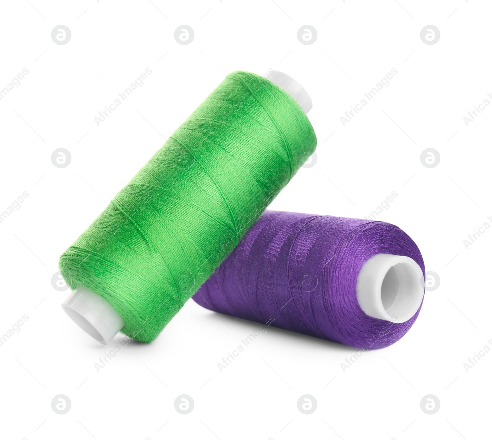 Photo of Different colorful sewing threads on white background