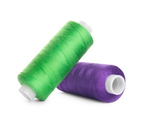 Photo of Different colorful sewing threads on white background