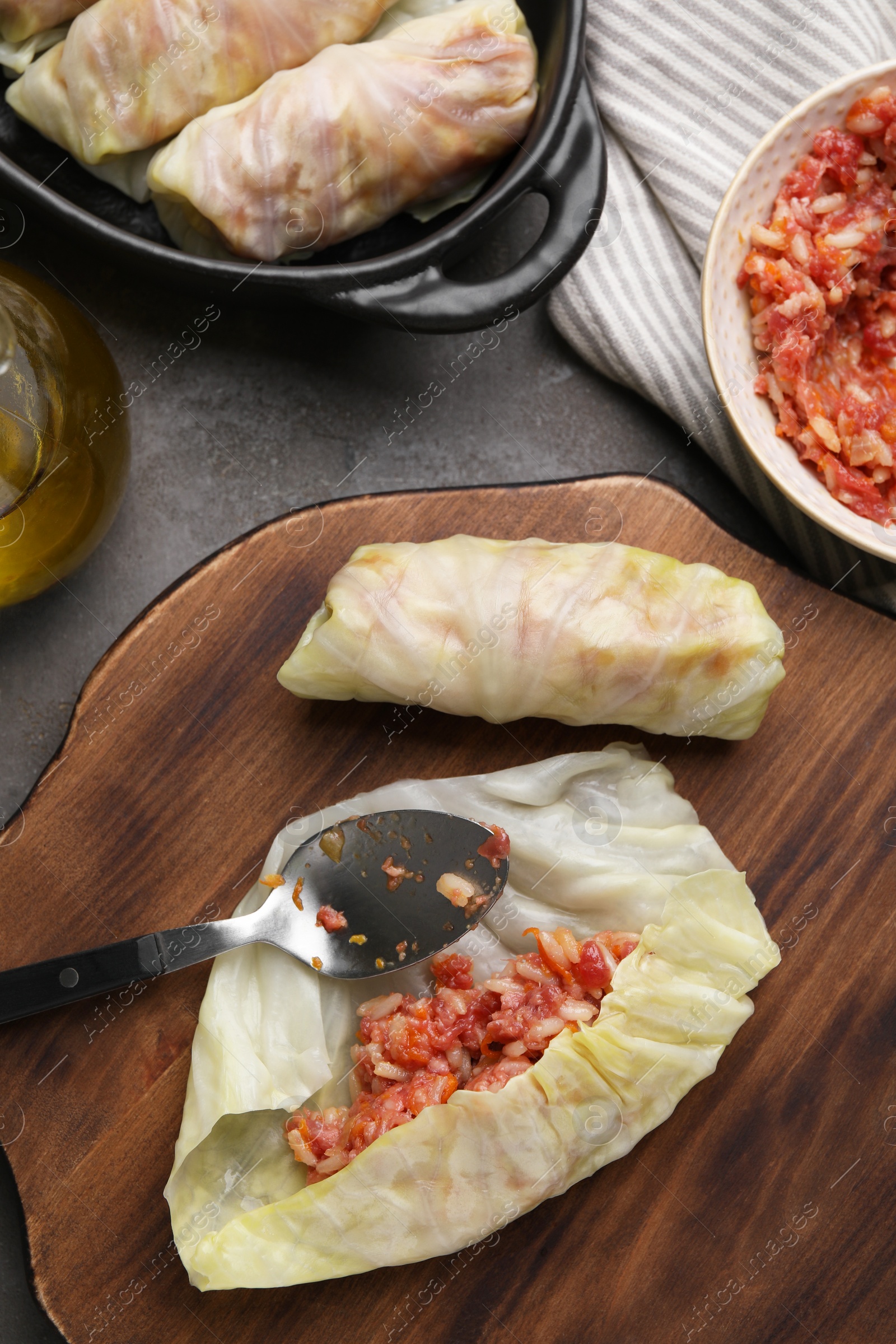 Photo of Preparing stuffed cabbage rolls on grey table, flat lay