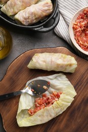 Photo of Preparing stuffed cabbage rolls on grey table, flat lay