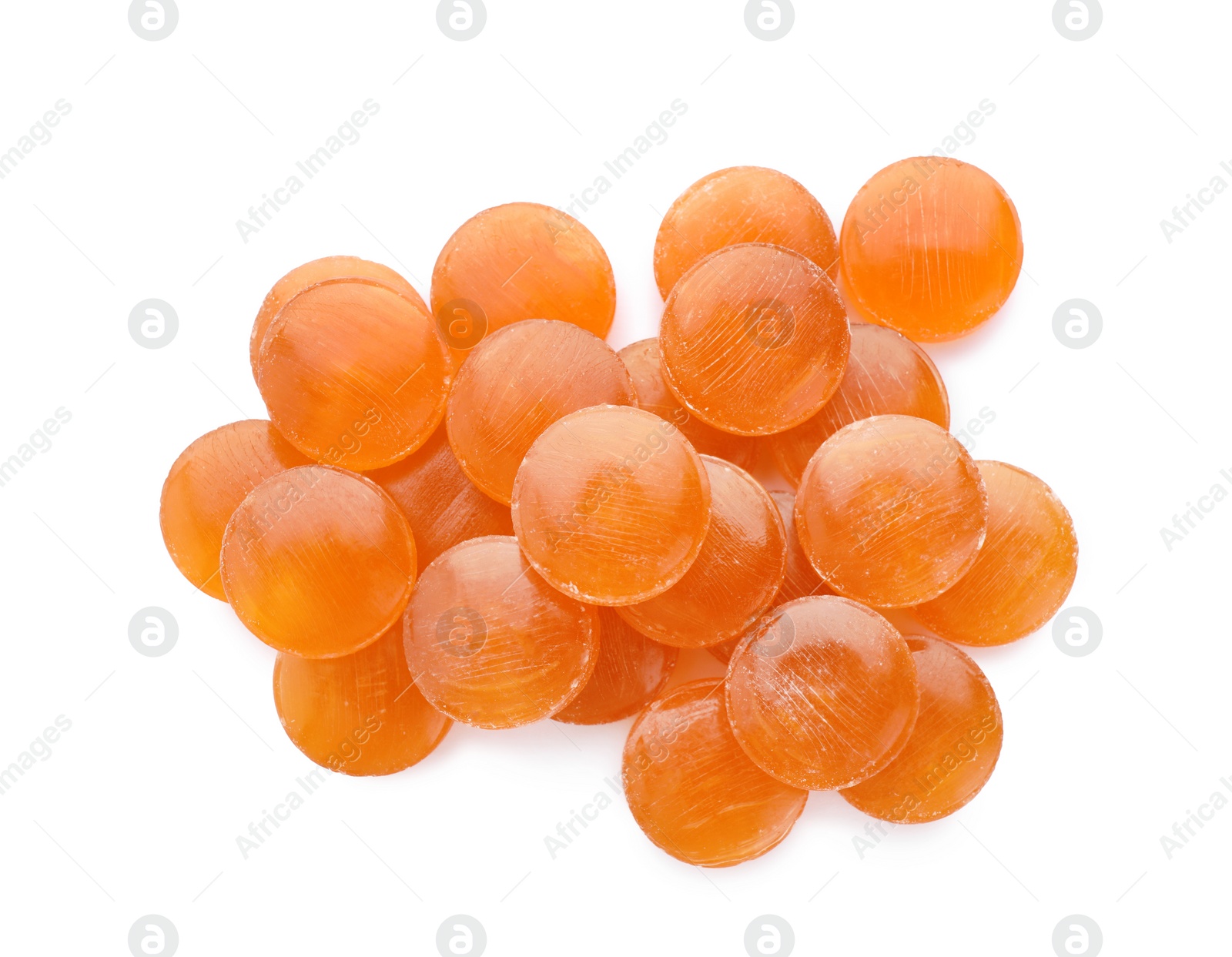 Photo of Many orange cough drops on white background, top view