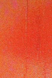 Photo of Orange textured surface as background, closeup view