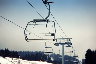 Photo of Empty chairlift at ski resort. Winter vacation