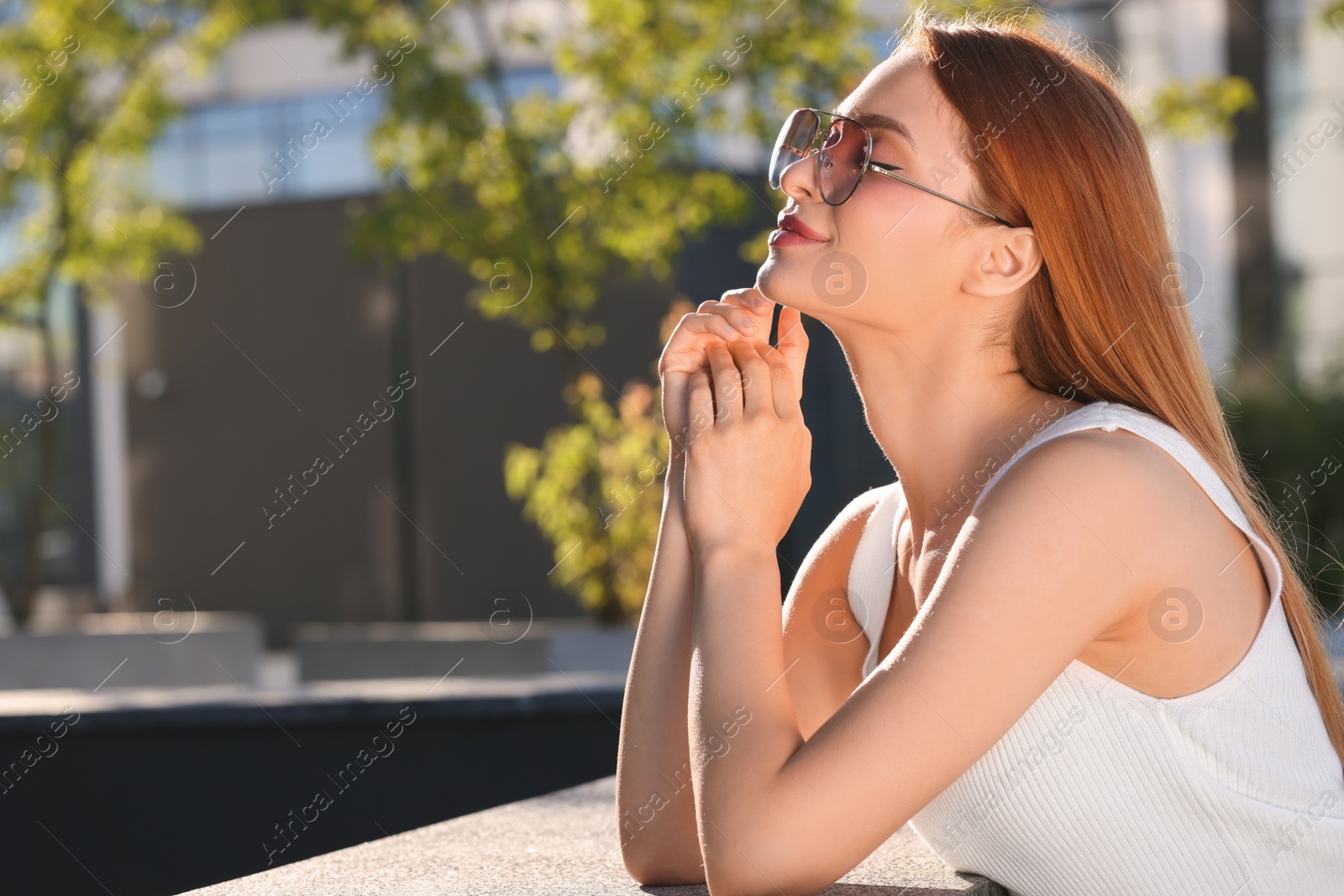 Photo of Beautiful woman in sunglasses outdoors, space for text