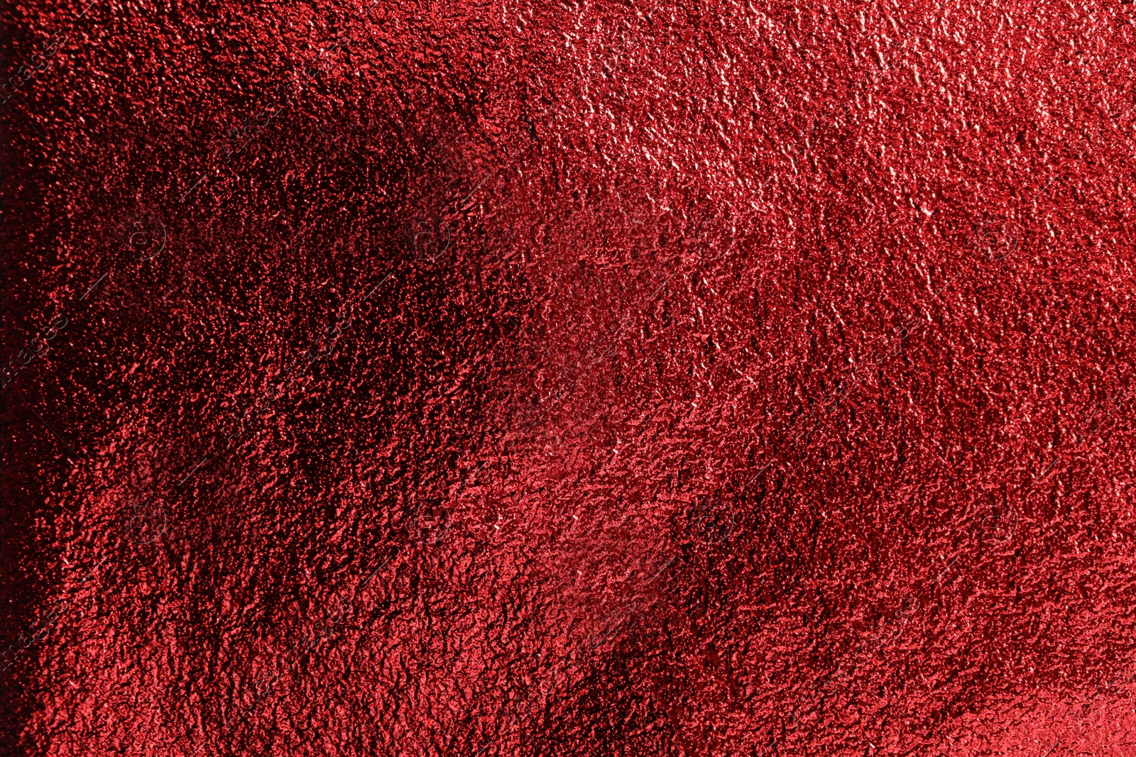 Photo of Textured red foil as background, top view