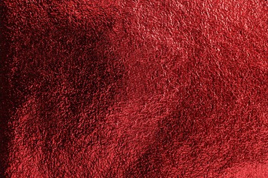 Photo of Textured red foil as background, top view