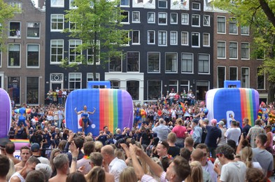 Photo of AMSTERDAM, NETHERLANDS - AUGUST 06, 2022: Many people at LGBT pride parade on summer day