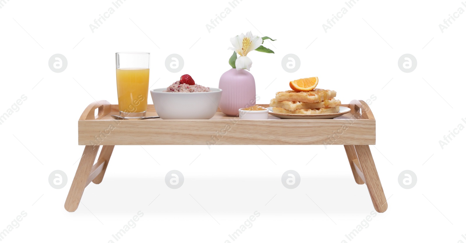 Photo of Wooden tray with delicious breakfast and beautiful flower on white background