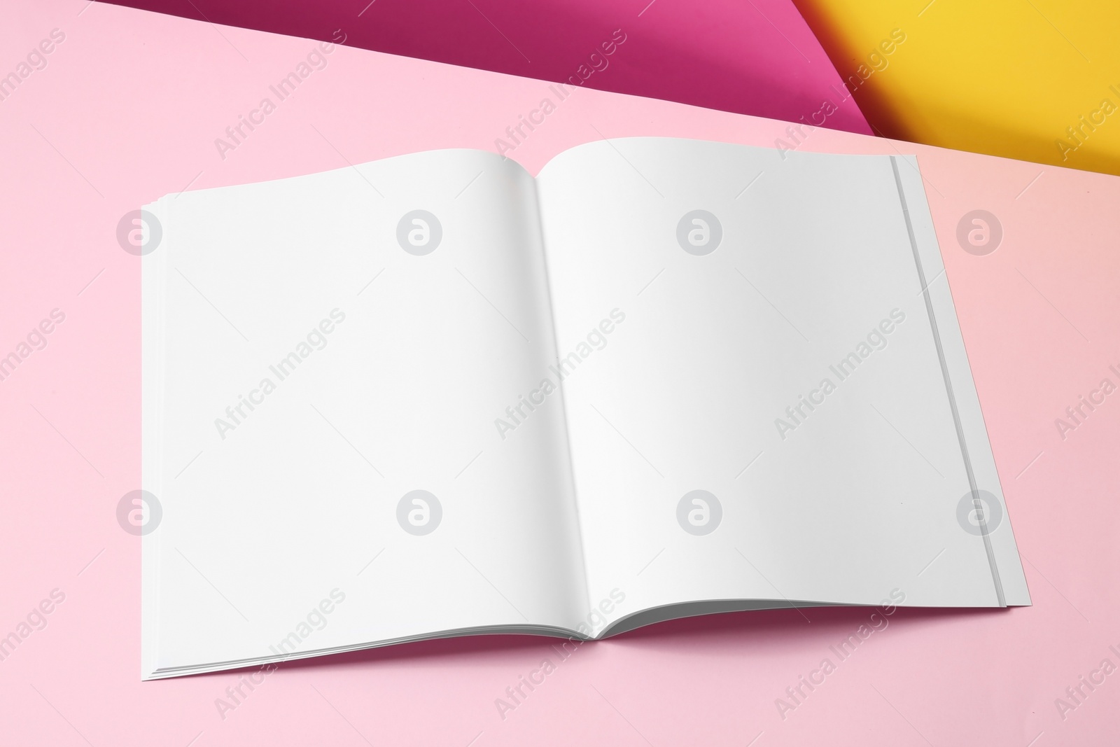 Photo of Empty book pages on color background. Mockup for design