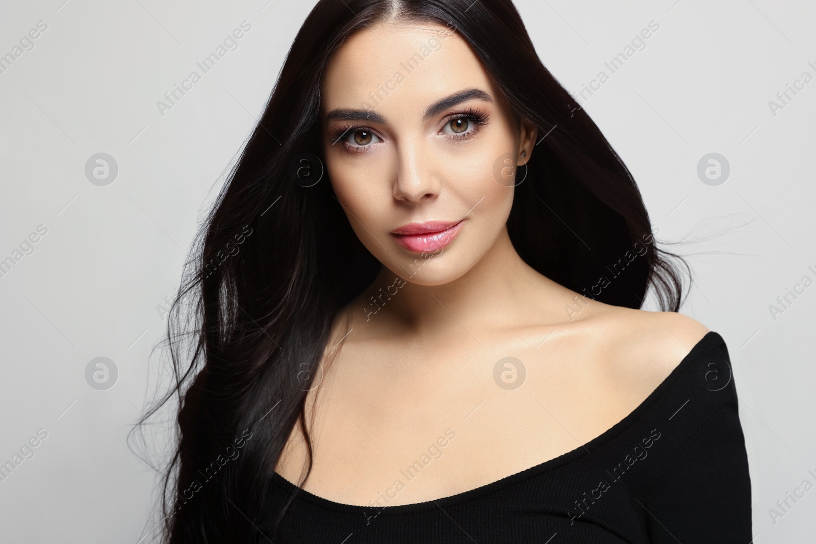 Photo of Portrait of beautiful young woman on light grey background