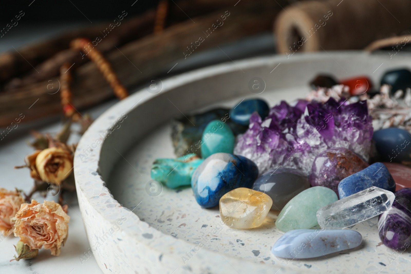 Photo of Pile of different beautiful gemstones in tray