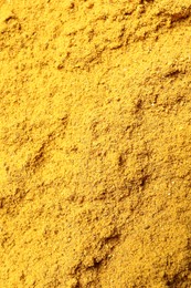 Photo of Dry curry powder as background, top view