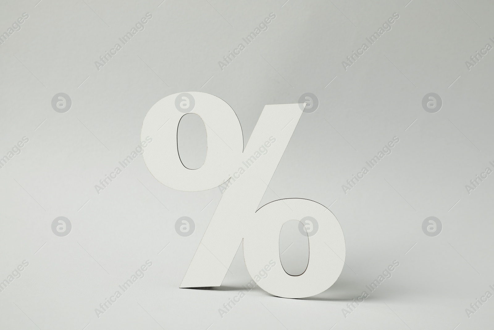 Photo of White percent sign on light grey background