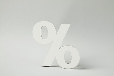 White percent sign on light grey background