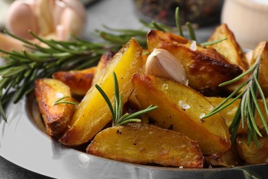 Photo of Tasty baked potato and aromatic rosemary on plate, closeup