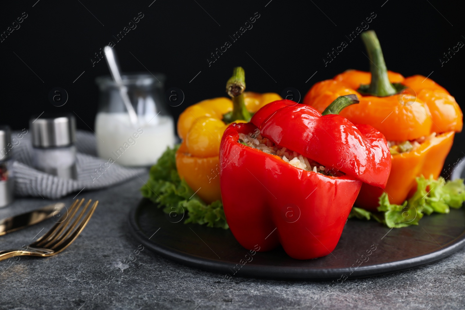 Photo of Tasty stuffed bell peppers on grey table