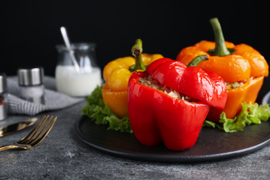 Photo of Tasty stuffed bell peppers on grey table