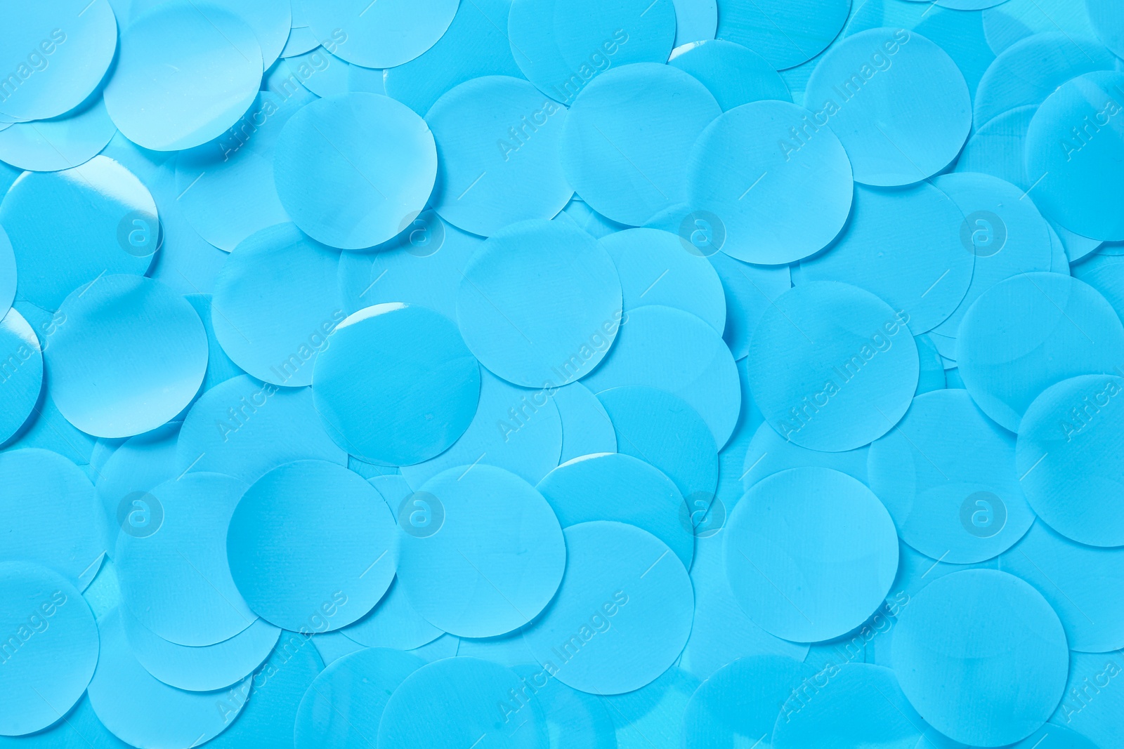 Photo of Many light blue confetti as background, top view